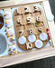 A set of white acrylic coins is used for hands-on learning