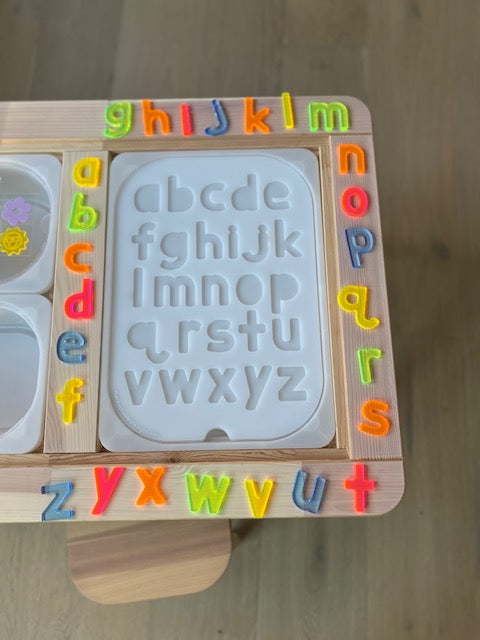 An acrylic letter learning board with resin letters